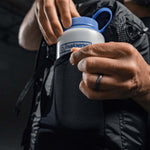 Man placing Nalgene bottle in backpack water bottle pocket