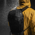 Man with backpack in rain