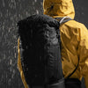 Man wearing backpack in the rain