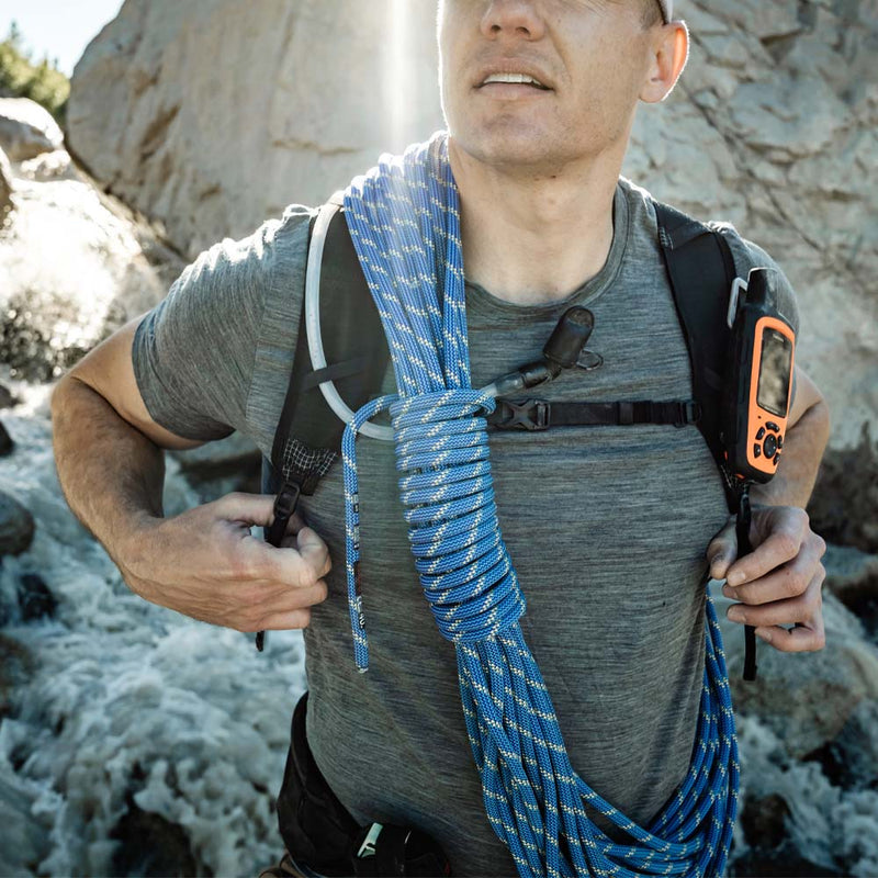 Man with climbing rope, wearing backpack with sternum strap