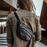 Woman walking around city wearing the hip pack cross body on back