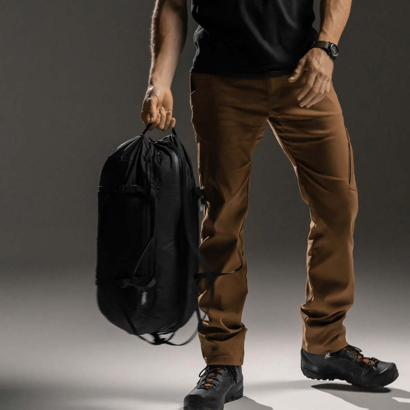 Man holding duffle from end carry handle