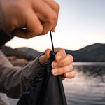 Hands pulling black Droplet drawstring closed