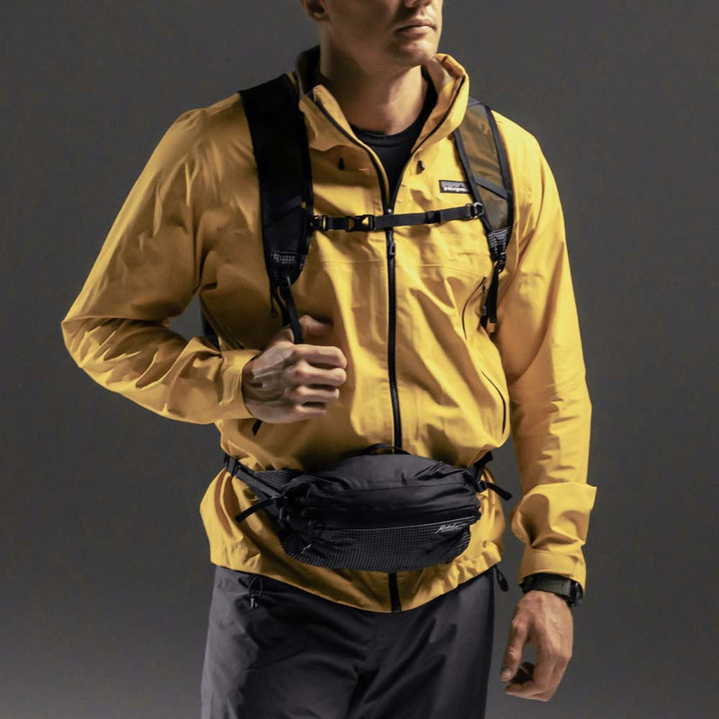 Man wearing backpack with hip pack on his waist