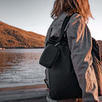 Woman on dock with charcoal nanodry case hanging from her shoulder bag