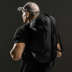 3/4 view of man wearing duffle as a backpack