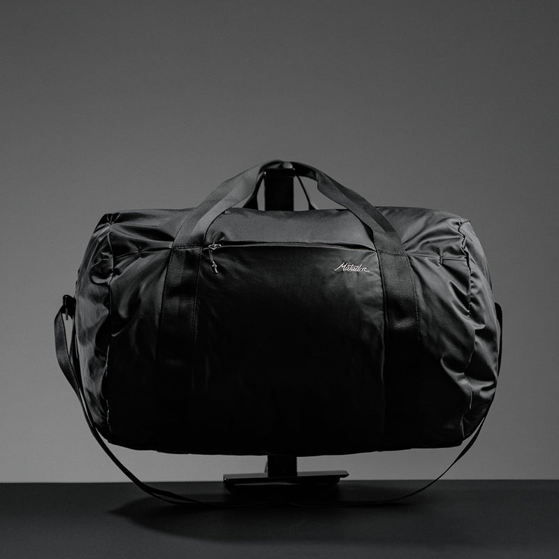 Packed duffle on black background