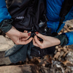 Woman clipping trek towel to backpack